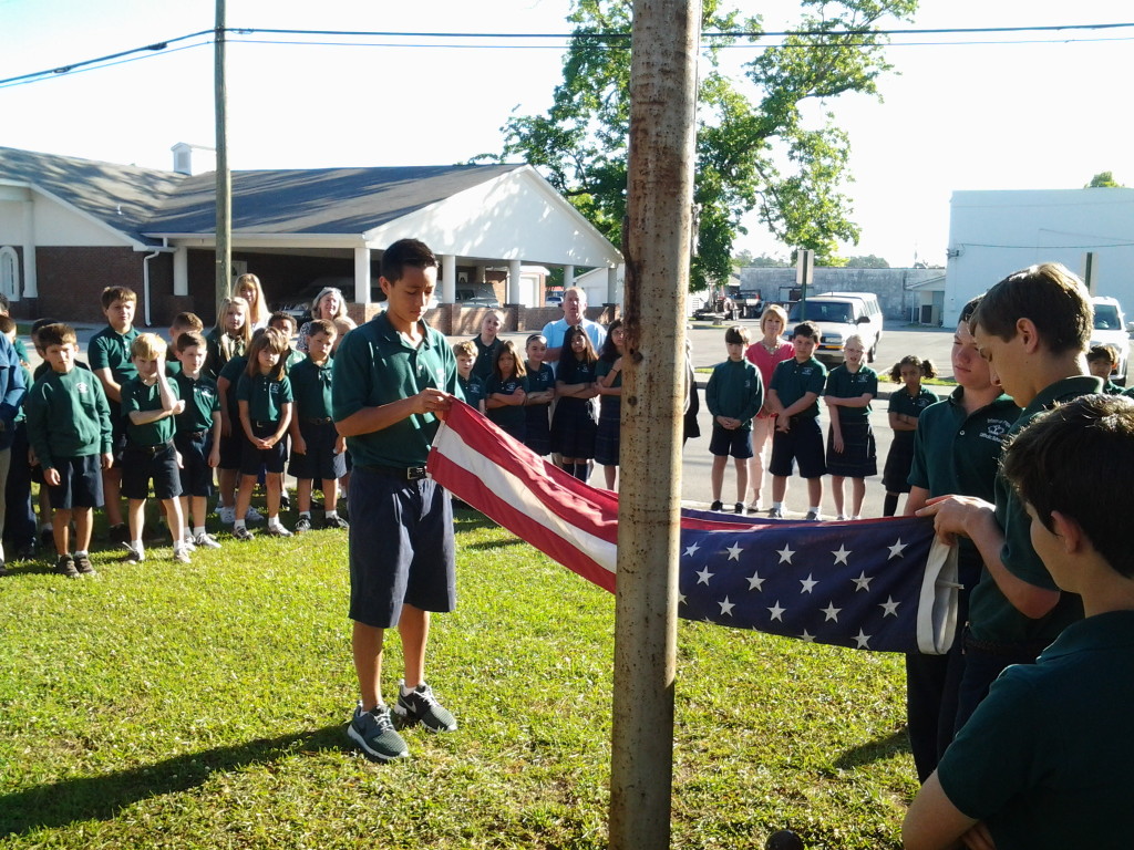 Flag Ceremony at Infant of Prague School on 2 June 2014. Out-going eighth grade class passing colors to incoming eighth graders. 
